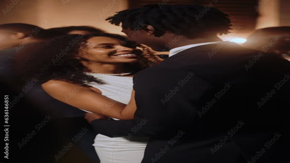 The bride and groom dance a slow dance among the guests outdoors at night The bride and groom dance a slow dance among the guests outdoors at night
