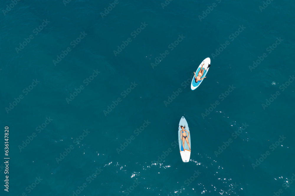 © Marko/Stocksy - Sunbathing on paddle boards © Marko/Stocksy - Sunbathing on paddle boards
