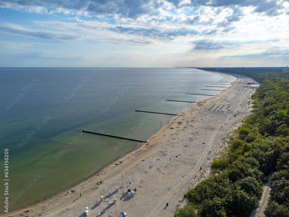 Aerial view landscape, view of beach, sea and pier in Kolobrzeg, Poland. Baltic sea. Forest , clouds.