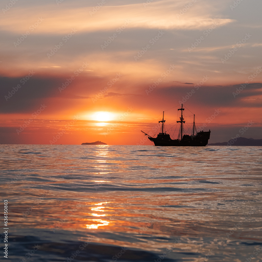Orange sunset with
old historical tall ship (yacht) in sea. Orange sunset with
old historical tall ship (yacht) in sea.