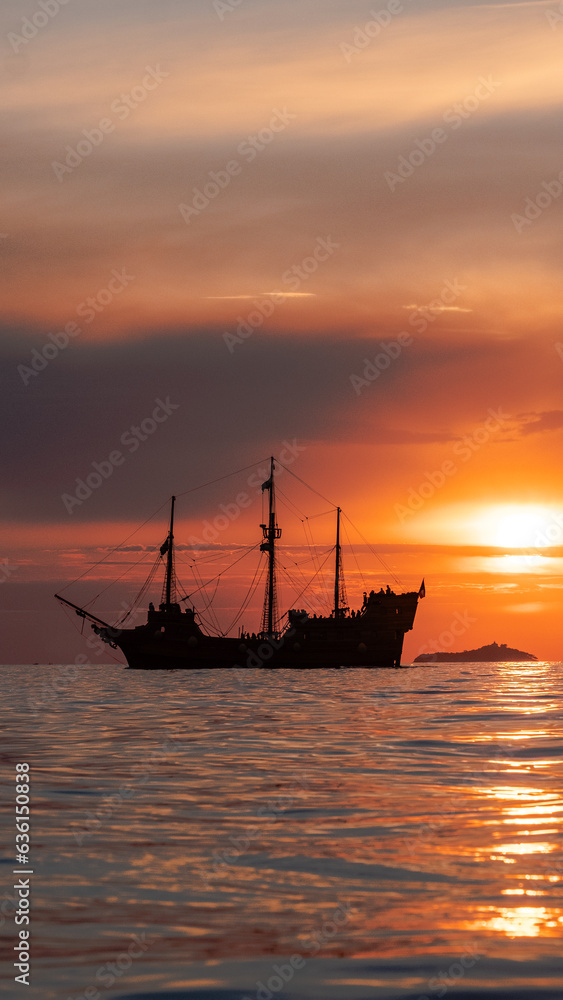 Orange sunset with
old historical tall ship (yacht) in sea. Orange sunset with
old historical tall ship (yacht) in sea.