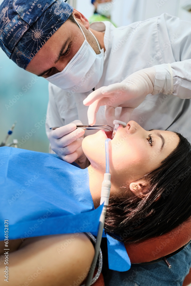 Young woman examining her teeth at the dentist's office Young woman examining her teeth at the dentist's office