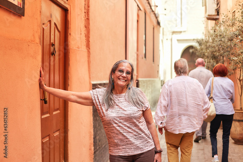 A mature woman is walking in the streets of Marrakesh. photo