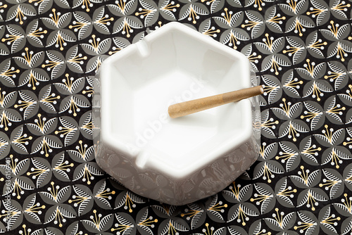 Cannabis preroll in ceramic ashtray on patterned background photo