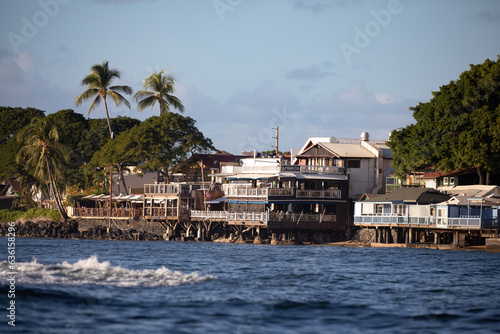 A view of historic Front Street stores and restaurants in the whaling town of Lahaina Maui Hawaii as seen from the harbor.  