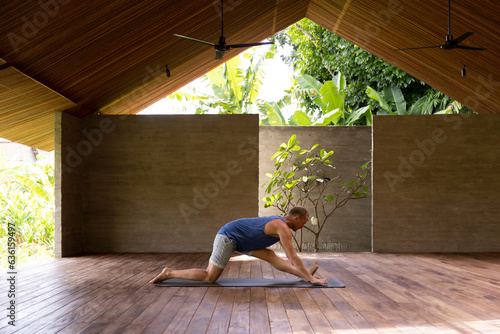 Adult man doing yoga in retreat centre photo