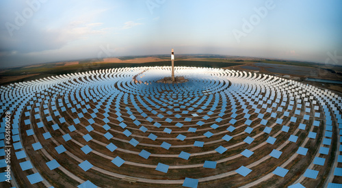 Solar power tower, mirrors, EU - green energy transition - aerial dusk