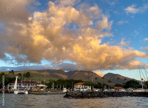 Colorful clouds at sunset over the boats in the harbor in the historic whaling village of Lahaina, Maui, Hawaii