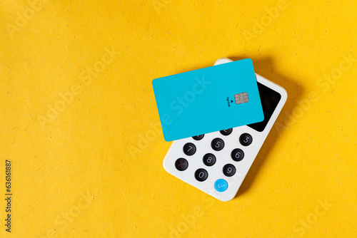 Wireless payment with a blue credit card on a terminal