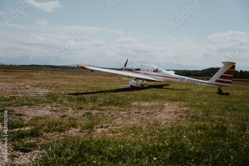 Glider plane preparing to take off surrounded by mountains in Nowy Targ, Zakopane in Poland. The sky and the view are visible in the background