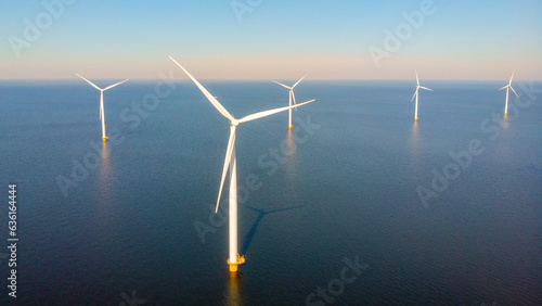 offshore windmill park with clouds and a blue sky, windmill park in the ocean aerial view with wind turbine Flevoland Netherlands Ijsselmeer. Green Energy in the Netherlands