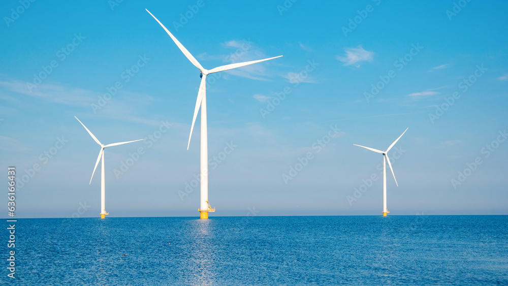 offshore windmill park with clouds and a blue sky, windmill park in the ocean aerial view with wind turbine Flevoland Netherlands Ijsselmeer. Green Energy in the Netherlands