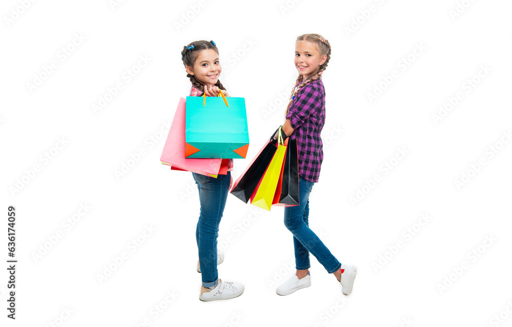 Fototapeta premium teen children go shopping. girls with shopping bags. shopping sale and discount. teen children girls with bags. Girls enjoying a day of shopping