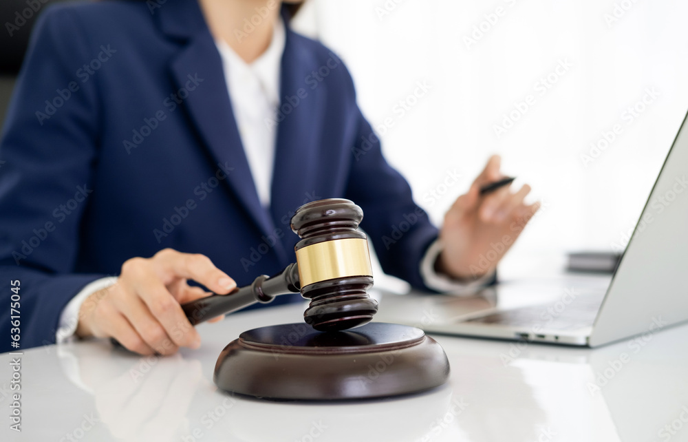 Focus closeup wooden gavel on blurred background of lawyer colleagues or legal team working at law firm office. Hammer of justice for righteous and equality judgment. Equilibrium Focus closeup wooden gavel on blurred background of lawyer colleagues or legal team working at law firm office. Hammer of justice for righteous and equality judgment. Equilibrium