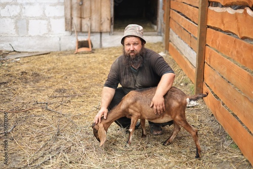  farmer with an Anglo-Nubian goat © Владимир Коврижник