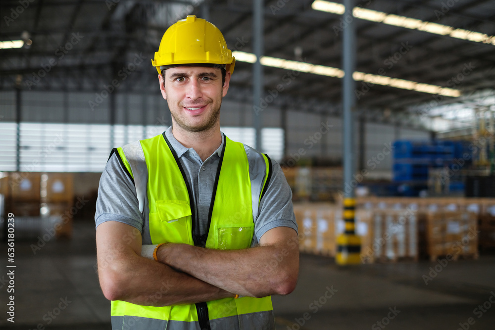 Portrait of caucasian male factory worker looking at camera with his arms crossed confidently in the process of working in warehouse. Portrait of caucasian male factory worker looking at camera with his arms crossed confidently in the process of working in warehouse.
