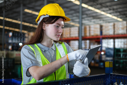 Female industrial engineer using tablet to inspect auto spare parts in the factory.Automobile industry and technology of warehouse.