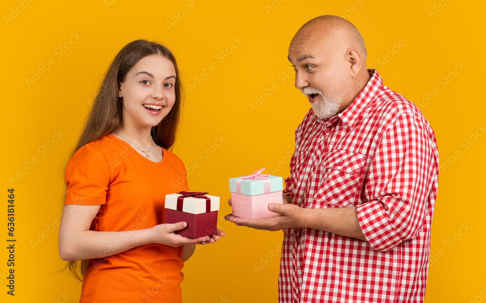 amazed kid and grandfather with present box for anniversary