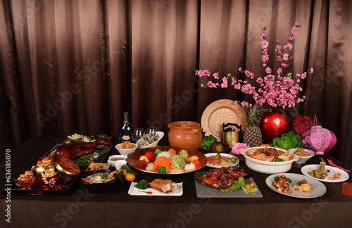 chinese new year festival asian food cuisine with meat, vegetable, noodle, cookies and yusheng lo hei with sakura flower lantern decoration on bronze background restaurant banquet halal dining menu