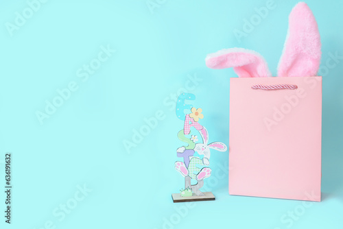 Pink gift bag with bunny ears and Easter figurine. Postcard, shopping, shopping, gift, surprise. High quality photo
