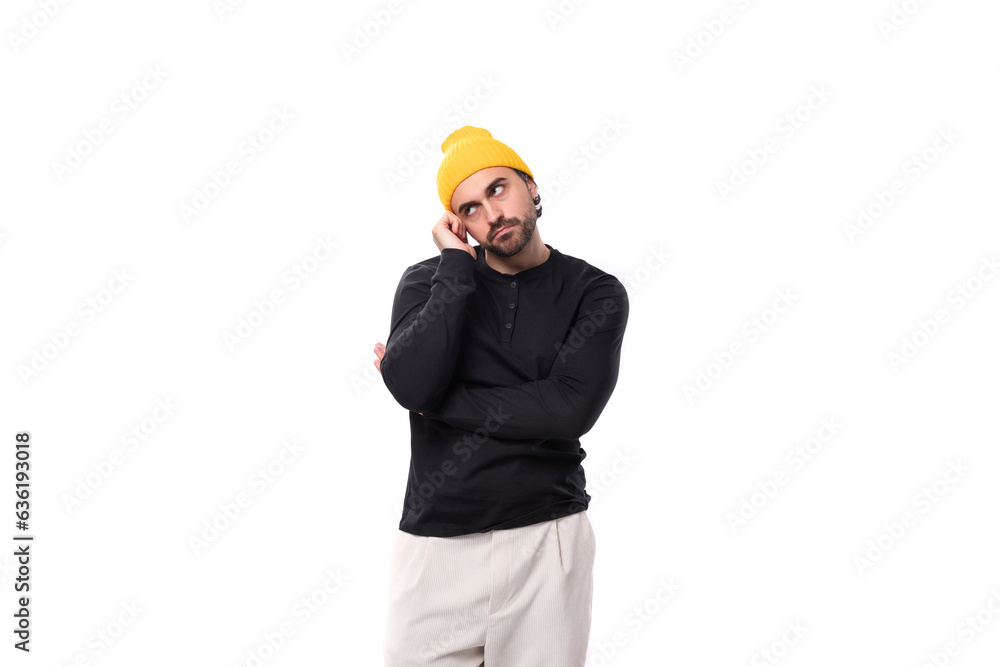 upset handsome young 30 year old guy dressed in a black jacket and a yellow hat upset handsome young 30 year old guy dressed in a black jacket and a yellow hat
