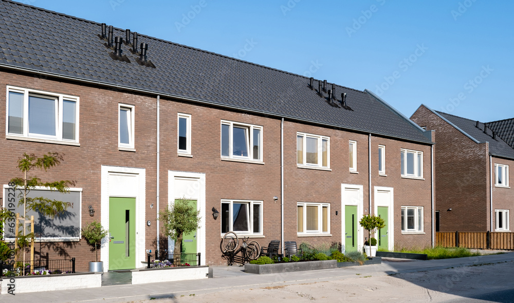 Dutch Suburban area with modern family houses, newly build modern family homes in the Netherlands, dutch family house in the Netherlands, Street with modern family houses in urban suburb 
