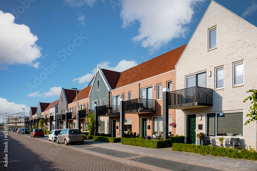 Wallpaper Mural Dutch Suburban area with modern family houses, newly built modern family homes in the Netherlands, nice and comfortable neighborhood. Some homes on the empty street in the suburbs of Urk Flevoland Torontodigital.ca