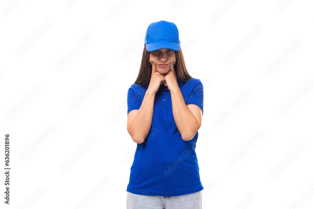 smiling pretty young brunette woman promoter in blue t-shirt and cap on white background with copy space smiling pretty young brunette woman promoter in blue t-shirt and cap on white background with copy space