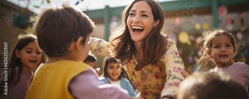 Obraz na płótnie Young kindergarten teacher is smiling and enjoying playing with kids outside during beautiful sunny day. w salonie