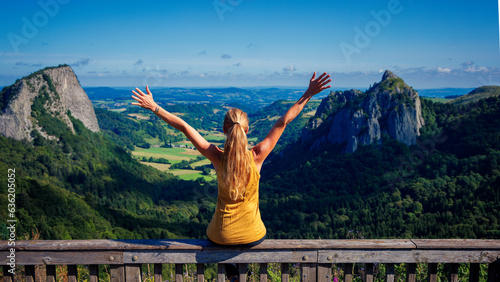 Hiker woman enjoying panoramic view of mountain peak in France- Auvergne © M.studio