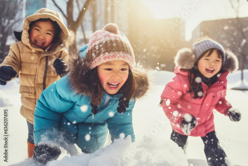 asian kids having fun and playing in the snow