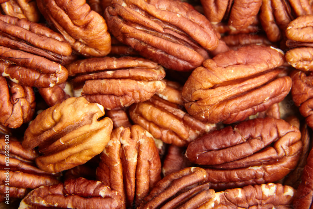 Pecan nuts kernel texture background closeup. Heap of peeled pecan halves. Pecans, a mosaic of shapes and shades Pecan nuts kernel texture background closeup. Heap of peeled pecan halves. Pecans, a mosaic of shapes and shades