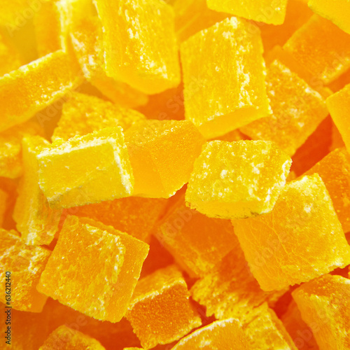Diced mango dried fruits texture background, top view. Dehydrated mango chips dices, sweet food closeup