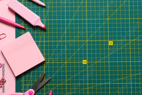 Patchwork accessories concept on pink background, mat cutting