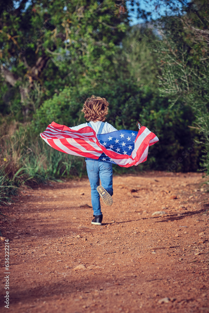 Unrecognizable boy running with American flag