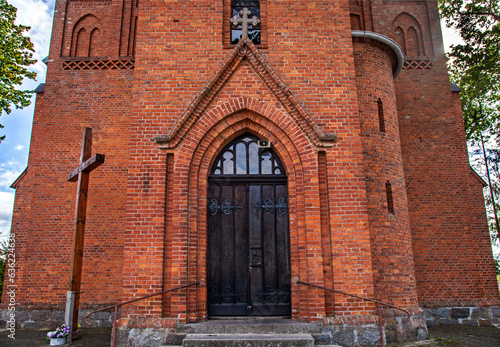 Fototapeta Naklejka Na Ścianę i Meble -  General view and close-up architectural details of the Catholic Church of St. Holy Trinity in the town of Dwawrzuty in Masuria in Poland.