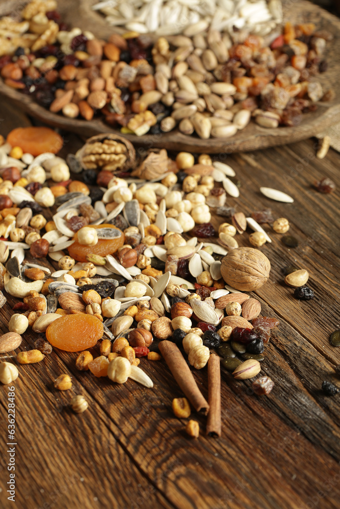 DRİED NUTS AND FRUİTS IN WOODEN BOWL ON BROWN FLOOR DRİED NUTS AND FRUİTS IN WOODEN BOWL ON BROWN FLOOR