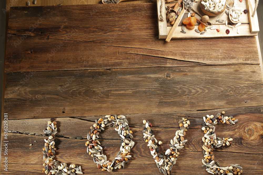 DRİED NUTS AND FRUİTS IN WOODEN BOWL ON BROWN FLOOR DRİED NUTS AND FRUİTS IN WOODEN BOWL ON BROWN FLOOR