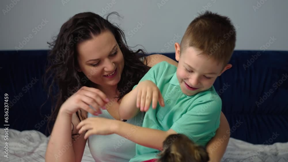 Mom and son are having fun and fooling around in the bedroom on the bed. Happy smiling cheerful family together mom hugs baby. Concept of care and love of parents, happy childhood. High quality 4k Mom and son are having fun and fooling around in the bedroom on the bed. Happy smiling cheerful family together mom hugs baby. Concept of care and love of parents, happy childhood. High quality 4k