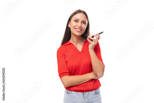 pretty caucasian woman with black hair is wearing a red blouse with a neckline chatting on the phone