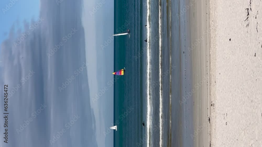 Vertical Fun day at beach, sailing and surfers. Vertical Fun day at beach, sailing and surfers.