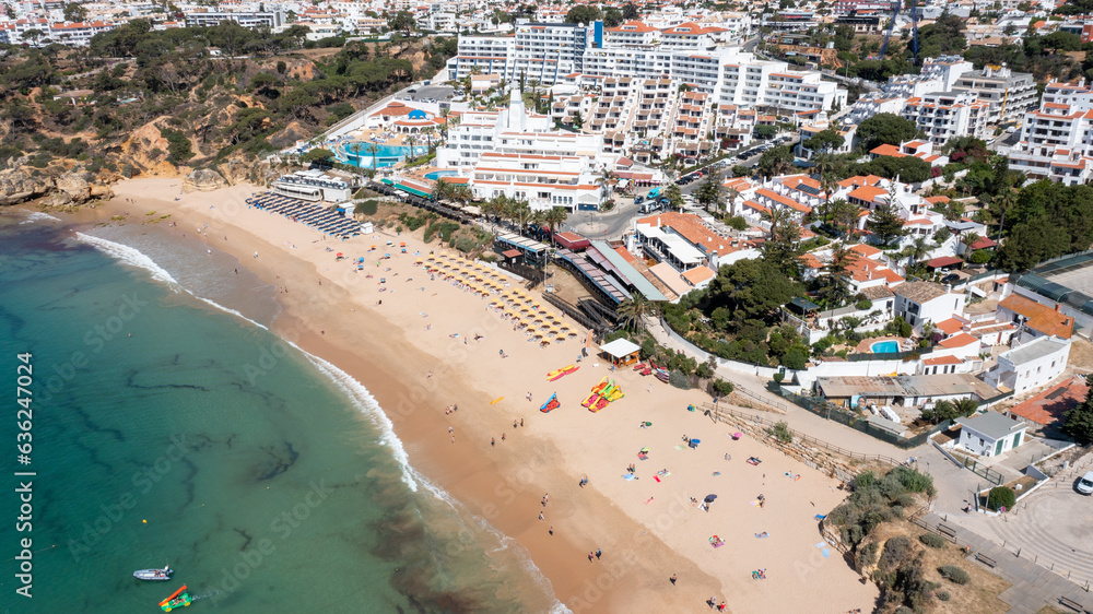 Aerial photo of the beautiful town in Albufeira in Portugal showing the Praia da Oura golden sandy beach, with hotels and apartment in the town, taken on a summers day in the summer time.