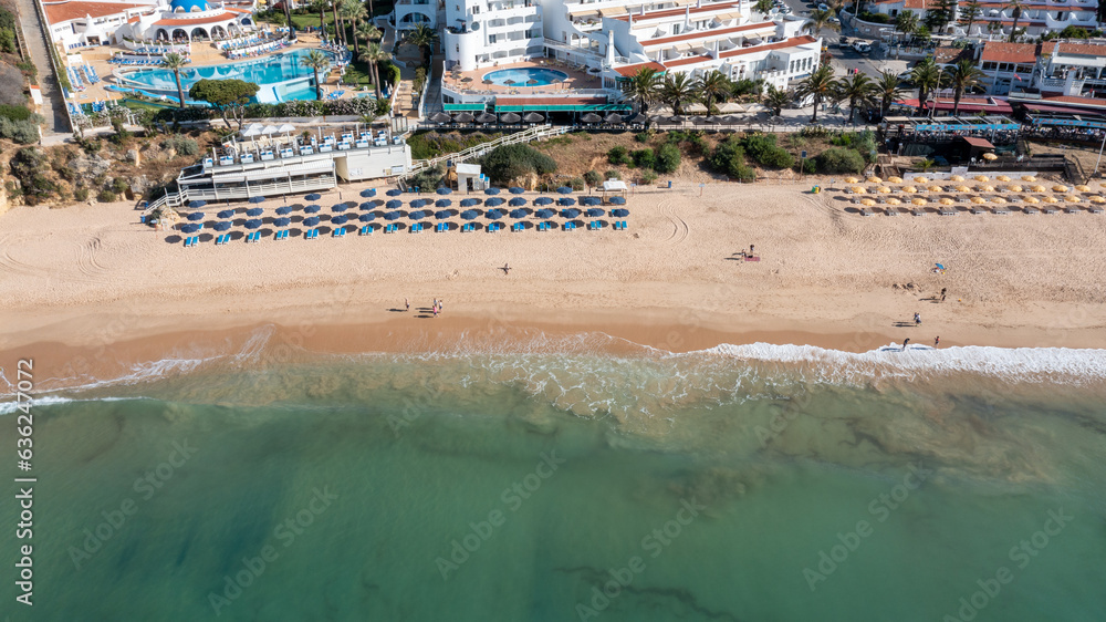 Aerial photo of the beautiful town in Albufeira in Portugal showing the Praia da Oura golden sandy beach, with hotels and apartment in the town, taken on a summers day in the summer time.