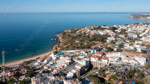 Aerial photo of the beautiful town in Albufeira in Portugal showing the Praia da Oura golden sandy beach, with hotels and apartment in the town, taken on a summers day in the summer time. © Duncan