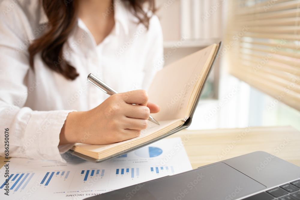 Asian woman taking notes in notebook while studying online in laptop at home, Video chat, Online communication , Stay home, New normal, Distance learning, Social distancing, Learn online... Asian woman taking notes in notebook while studying online in laptop at home, Video chat, Online communication , Stay home, New normal, Distance learning, Social distancing, Learn online...
