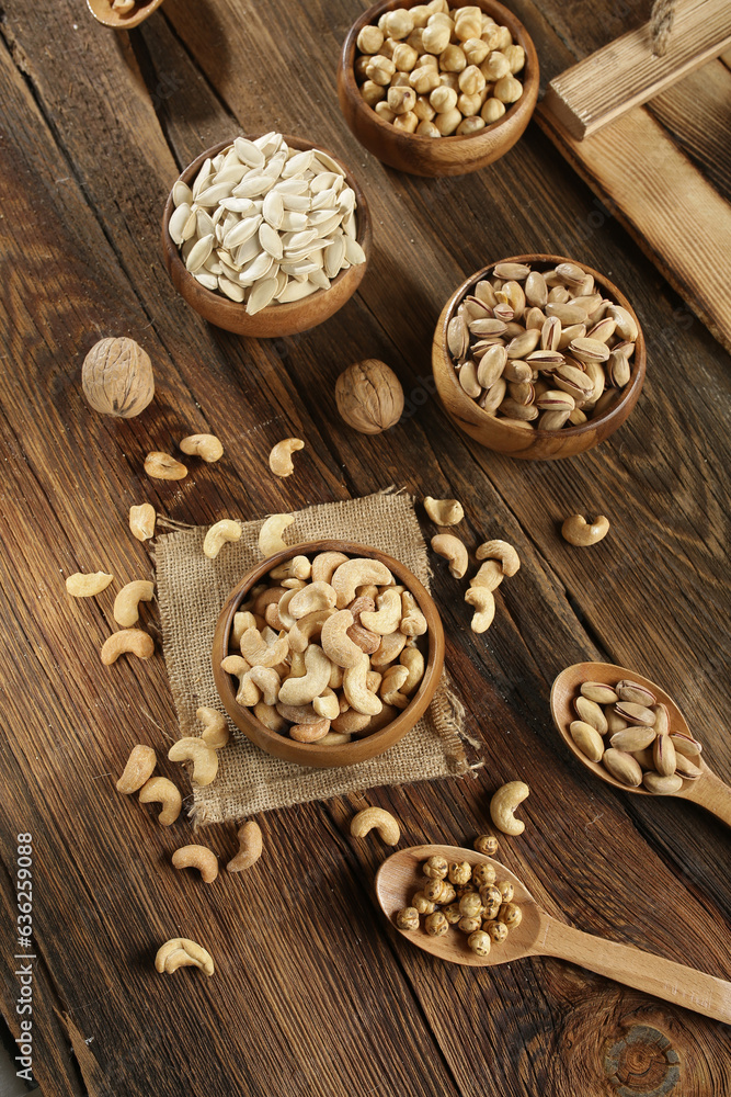 DRİED NUTS AND FRUİTS IN WOODEN BOWL ON BROWN FLOOR DRİED NUTS AND FRUİTS IN WOODEN BOWL ON BROWN FLOOR