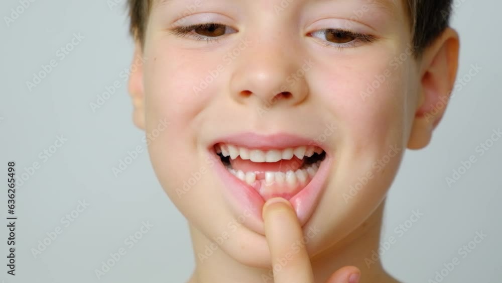 Loss of milk teeth in children. A six-year-old child shows the first baby tooth that has fallen out Loss of milk teeth in children. A six-year-old child shows the first baby tooth that has fallen out
