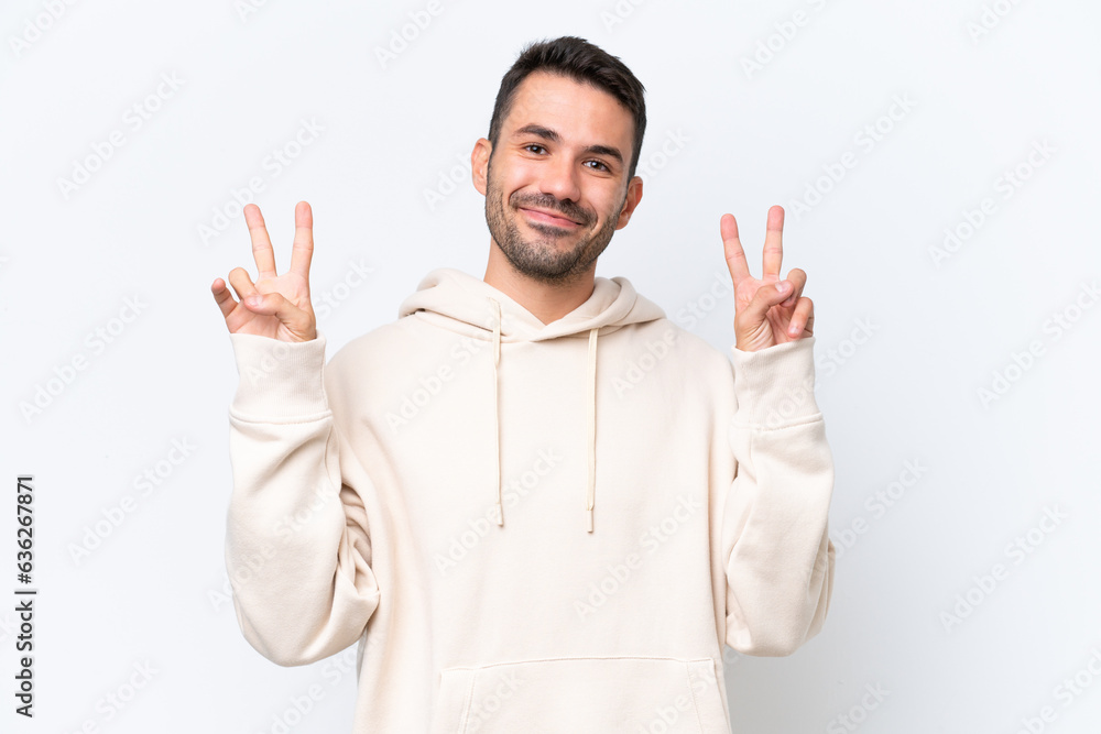 Young caucasian man isolated on white background showing victory sign with both hands Young caucasian man isolated on white background showing victory sign with both hands