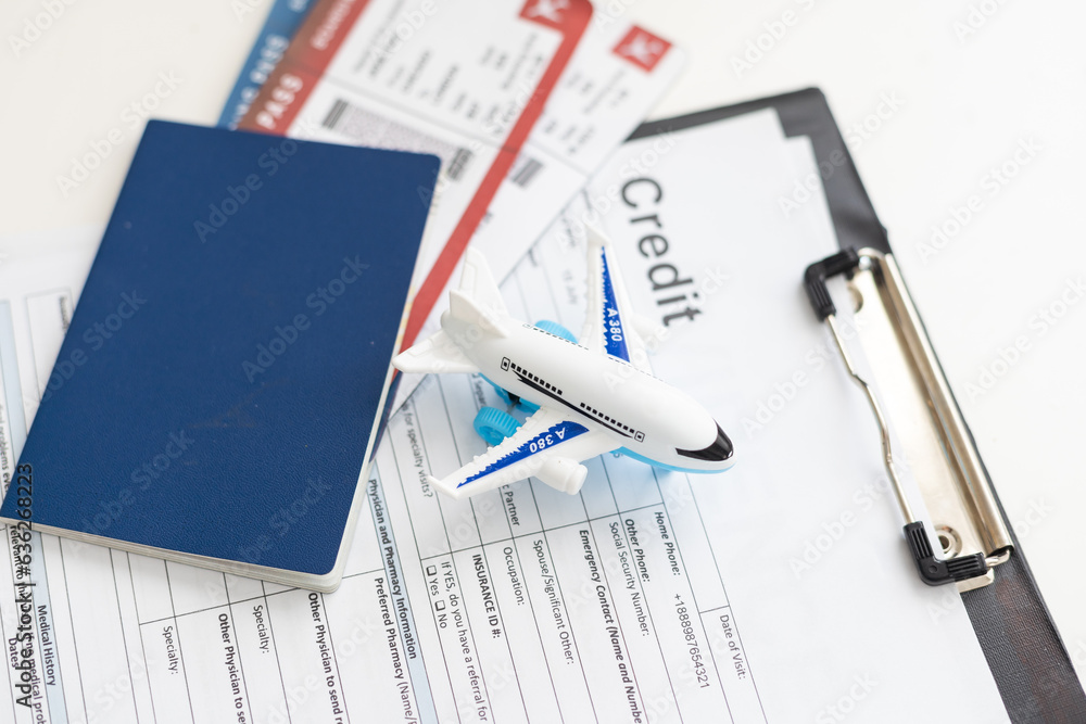 Toy plane and arrival card on white table. Travel insurance Toy plane and arrival card on white table. Travel insurance