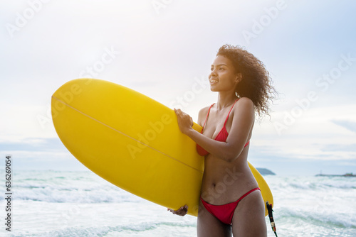 Woman playing surfboard on the beach in weekend activity, Sport extreme healthy lifestyle concept.